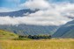 A view of Deplar Farm and the surrounding green mountainous valley.